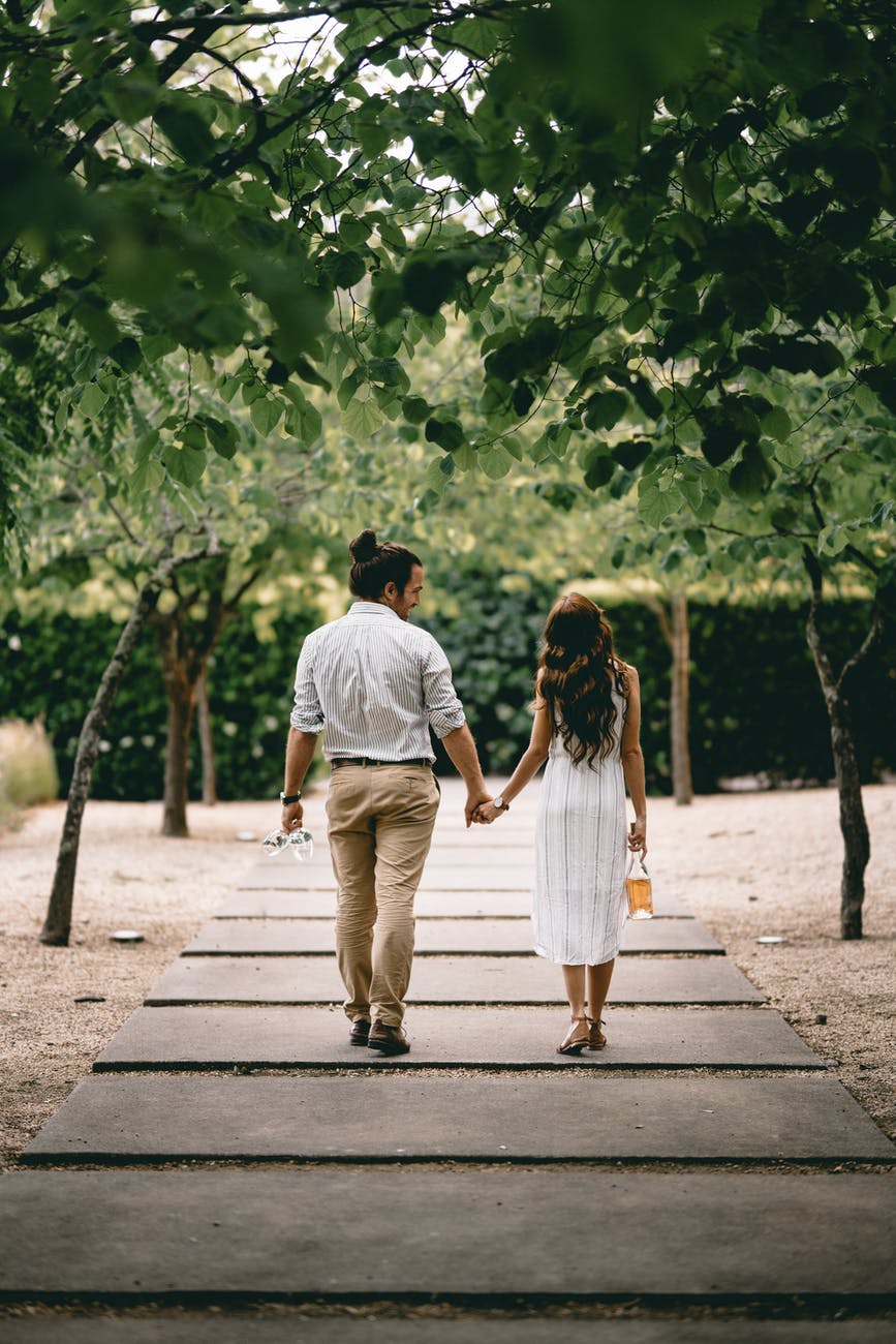 Couple holding hands on a romantic stroll.